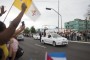 People react as Pope Francis arrives at the airport in Havana