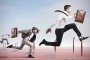 Business competition with jumping businessman over obstacle