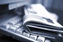 Newspapers on the computer keyboard close up