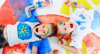 Two beautiful children enjoying their painting. Education.