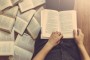 Woman reading a few books on the floor